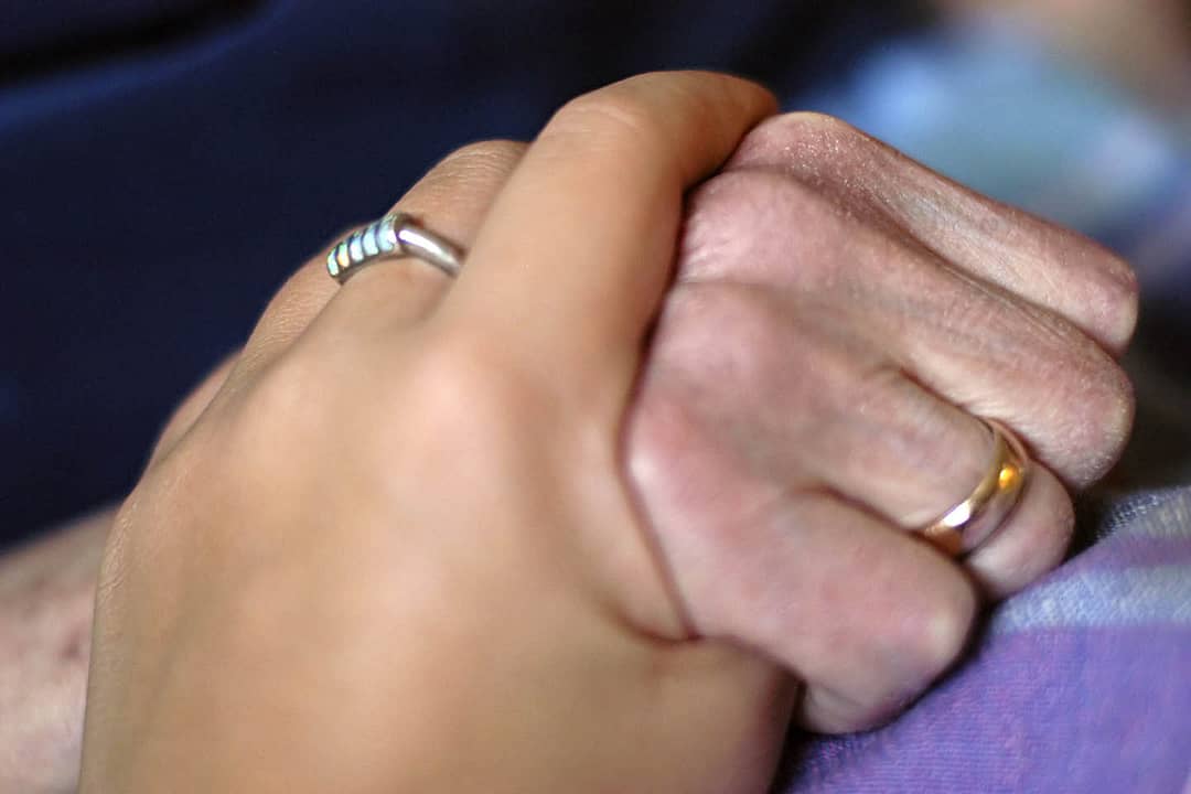 Hands of a young and an old lady who took Florissant Medicaid Planning